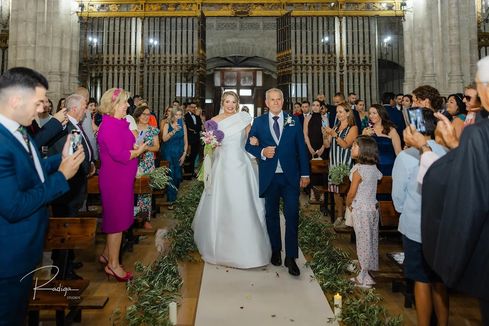 La novia entra por el pasillo de San Benito el Real entre los invitados