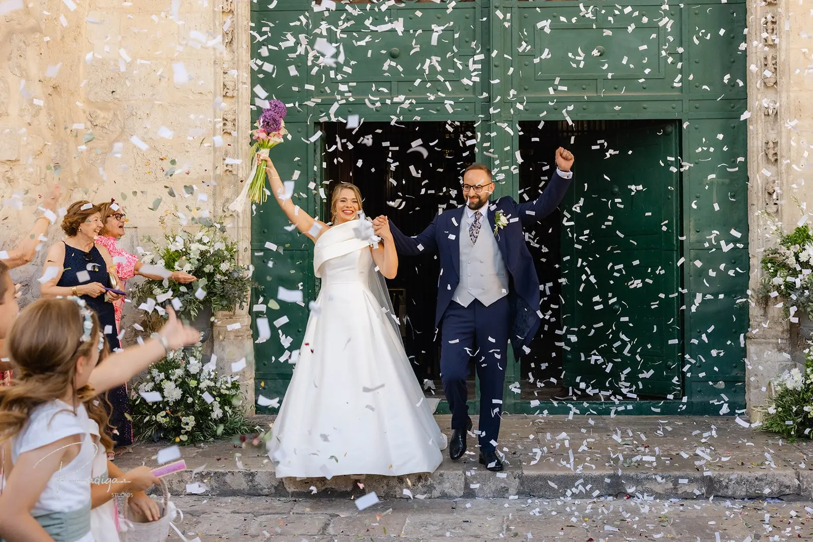 Los novios salen de la iglesia bajo una lluvia de pétalos