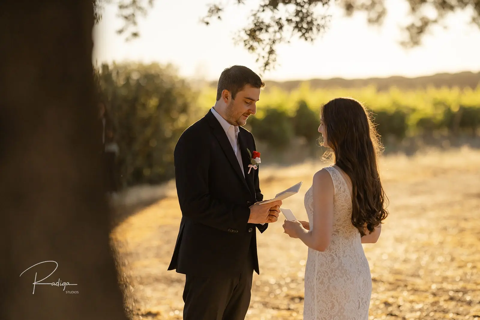 The couple reading their vows in the early morning light