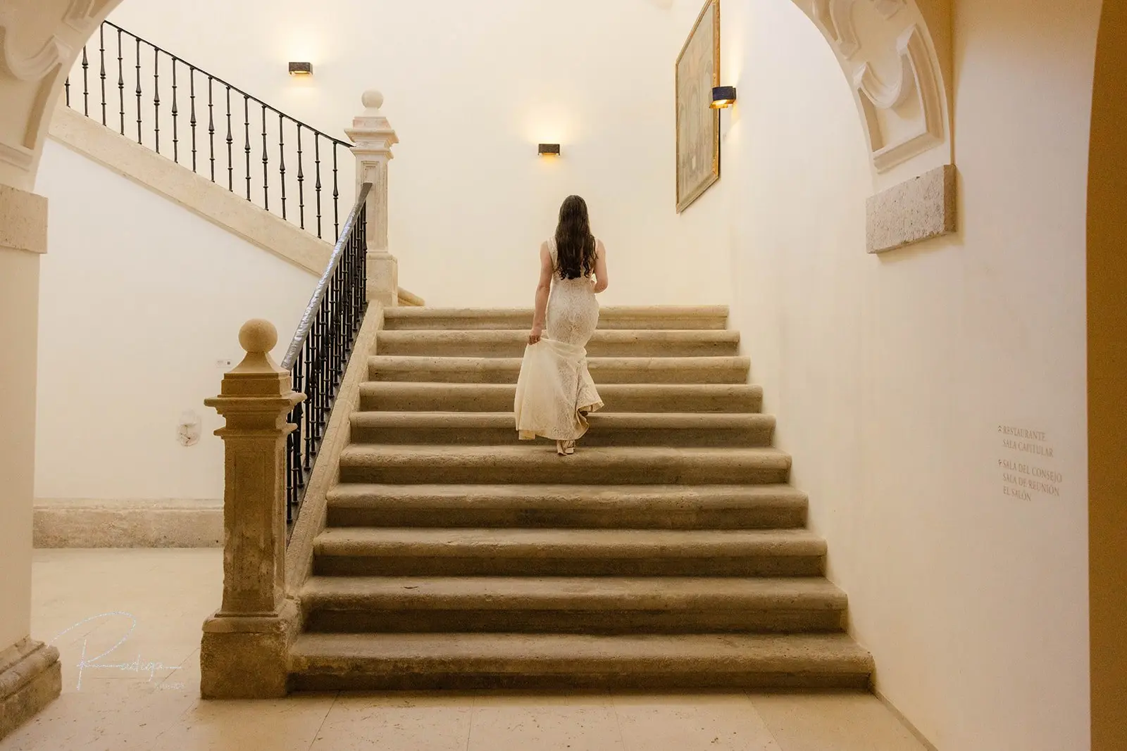 The bride climbing a stone staircase inside the monastery