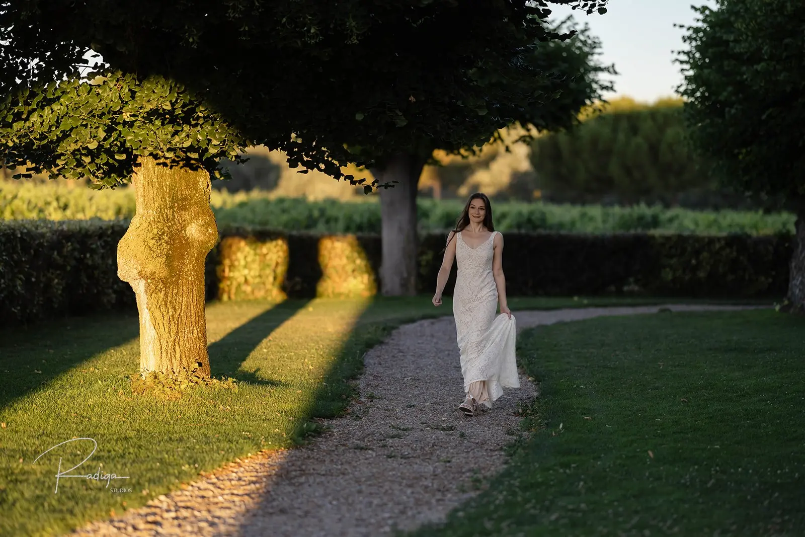 The bride walks along a garden path towards the first look