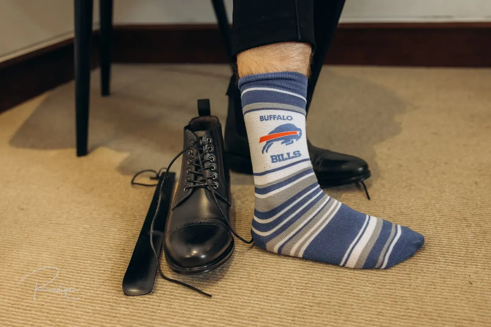The groom's colourful socks and black shoes