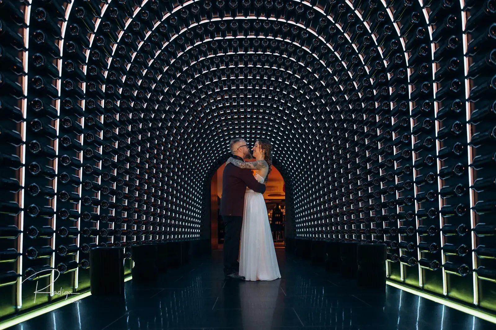 The couple in a tunnel of lights at the winery