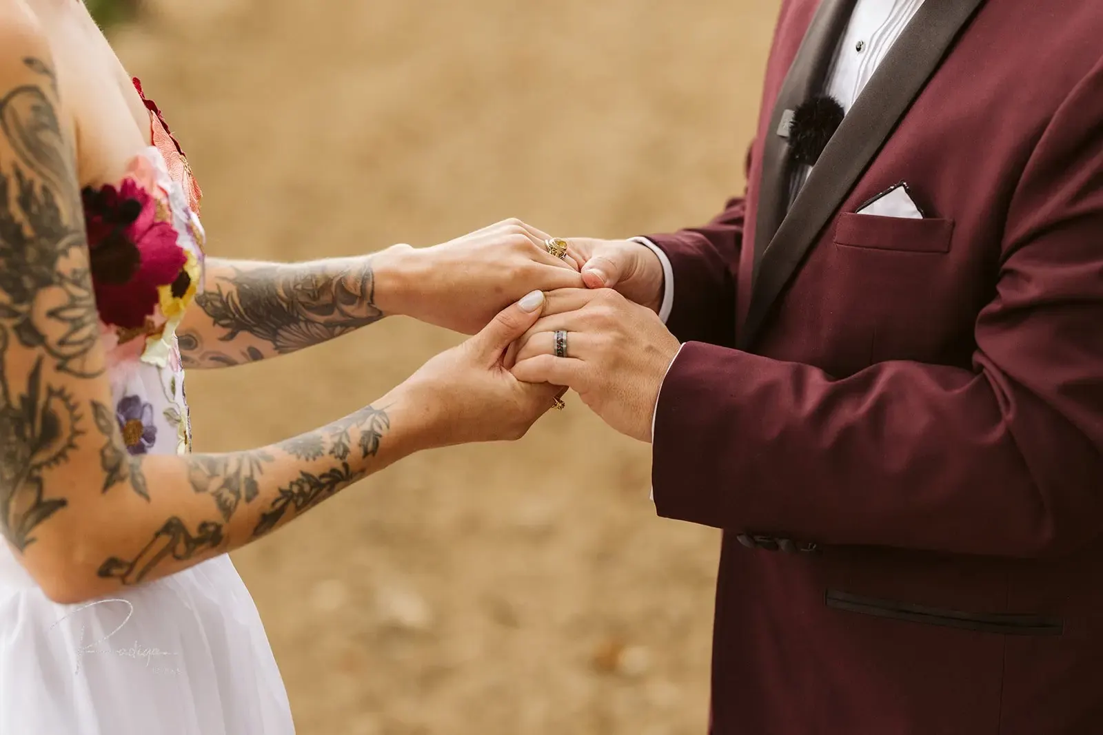 Close-up of the groom placing the ring on the bride's finger
